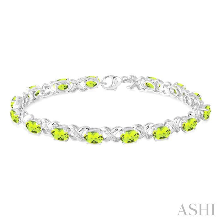 7x5  MM Oval Cut Peridot and 1/20 Ctw Round Cut Diamond Fashion Bracelet in Sterling Silver